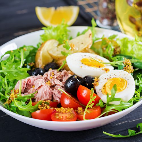 healthy-hearty-salad-tuna-green-beans-tomatoes-eggs-potatoes-black-olives-close-up-bowl-table