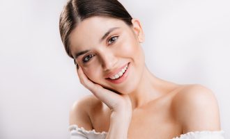 portrait-smiling-girl-with-healthy-skin-cute-dark-haired-woman-white-wall