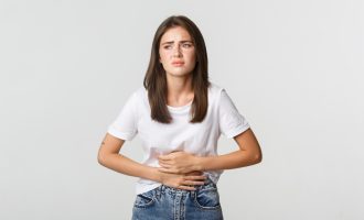 woman-having-stomach-ache-bending-with-hands-belly-discomfort-from-menstrual-cramps