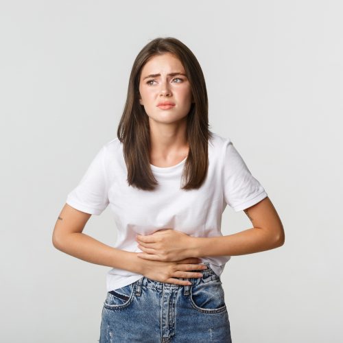 woman-having-stomach-ache-bending-with-hands-belly-discomfort-from-menstrual-cramps